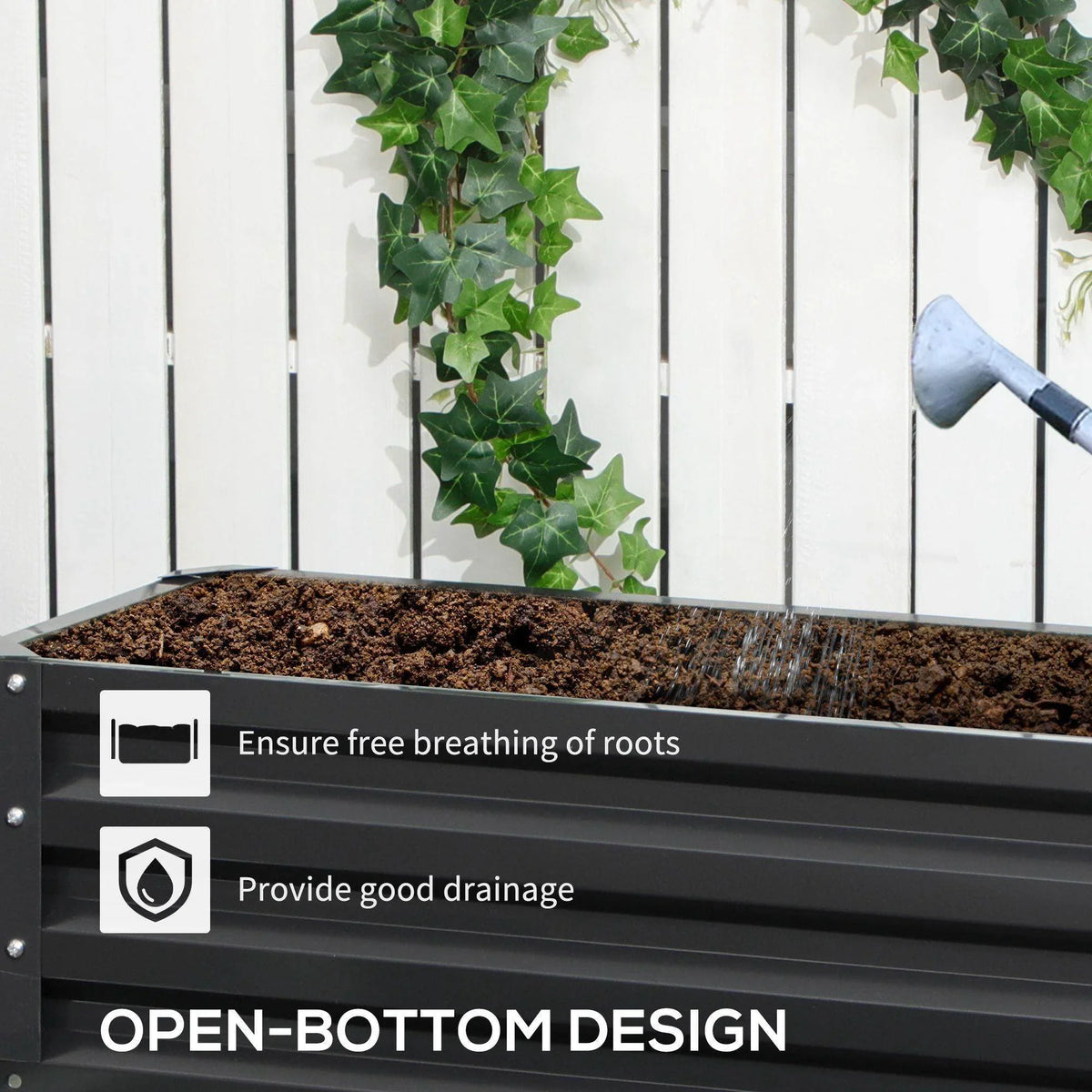 Open-bottom dark gray raised garden bed with metal slats, soil surface and hanging vines
