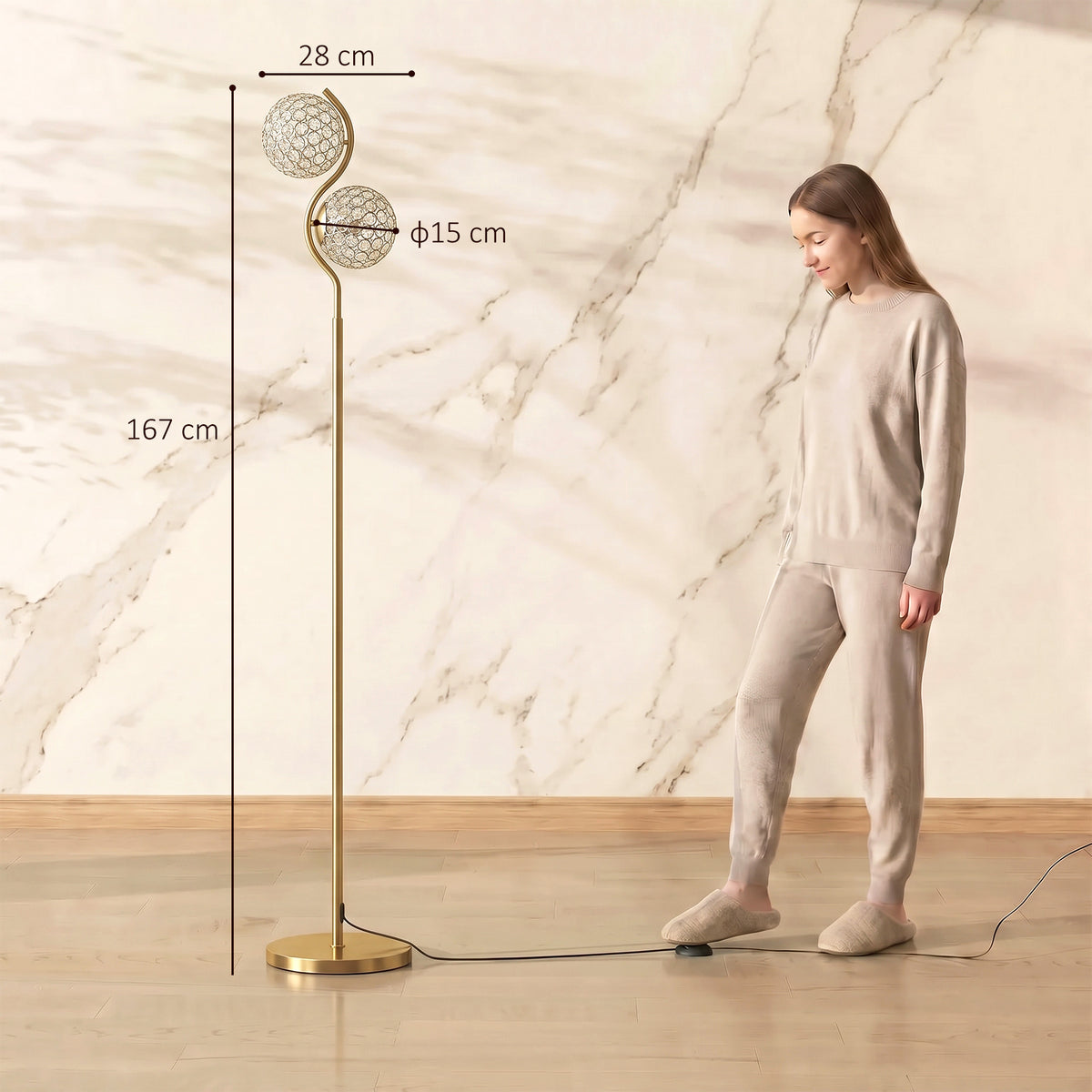 Tall dual head floor lamp with two globe shades on gold stand; next to standing person