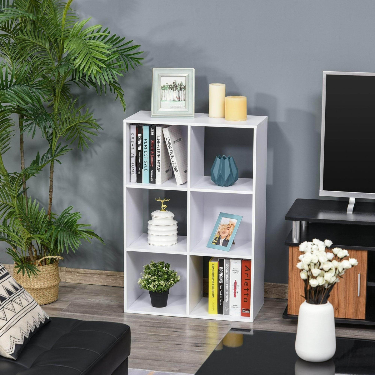 White 3-tier cube storage organizer with open compartments and book decor