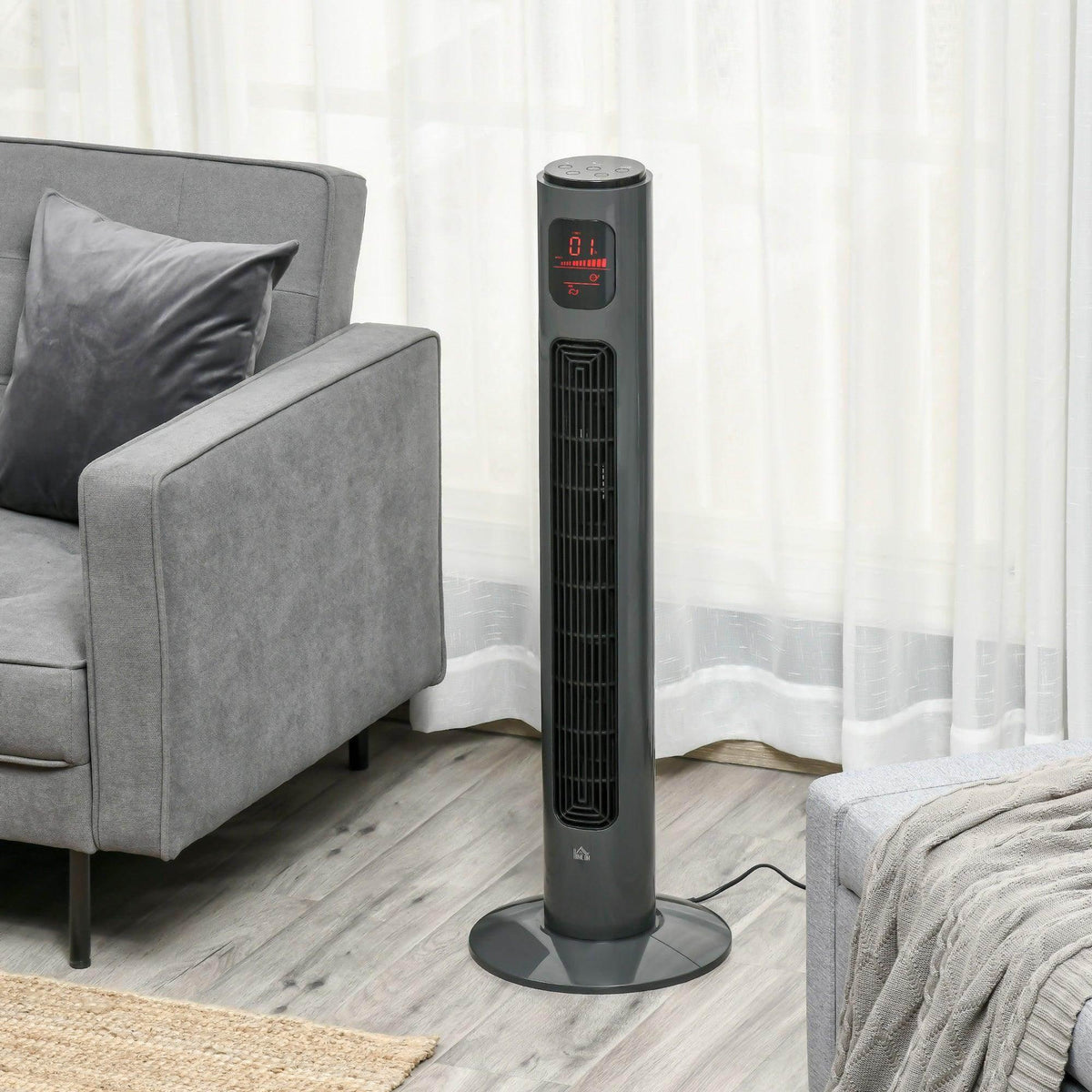 Black tower fan with slim column, standing on a round base