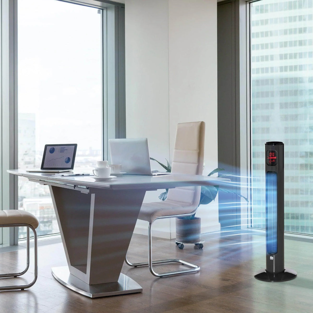 Black tower fan standing on the floor near an office desk