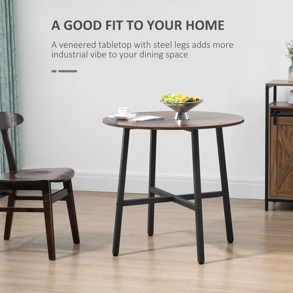 Industrial round dining table with brown tabletop and black powder-coated legs.