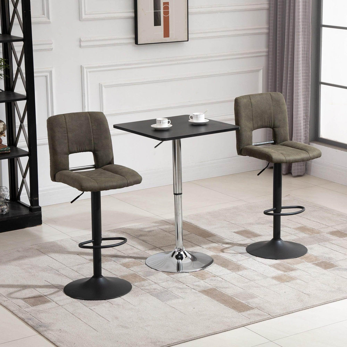 Black square bar table with chrome pedestal and round base in a lounge setting