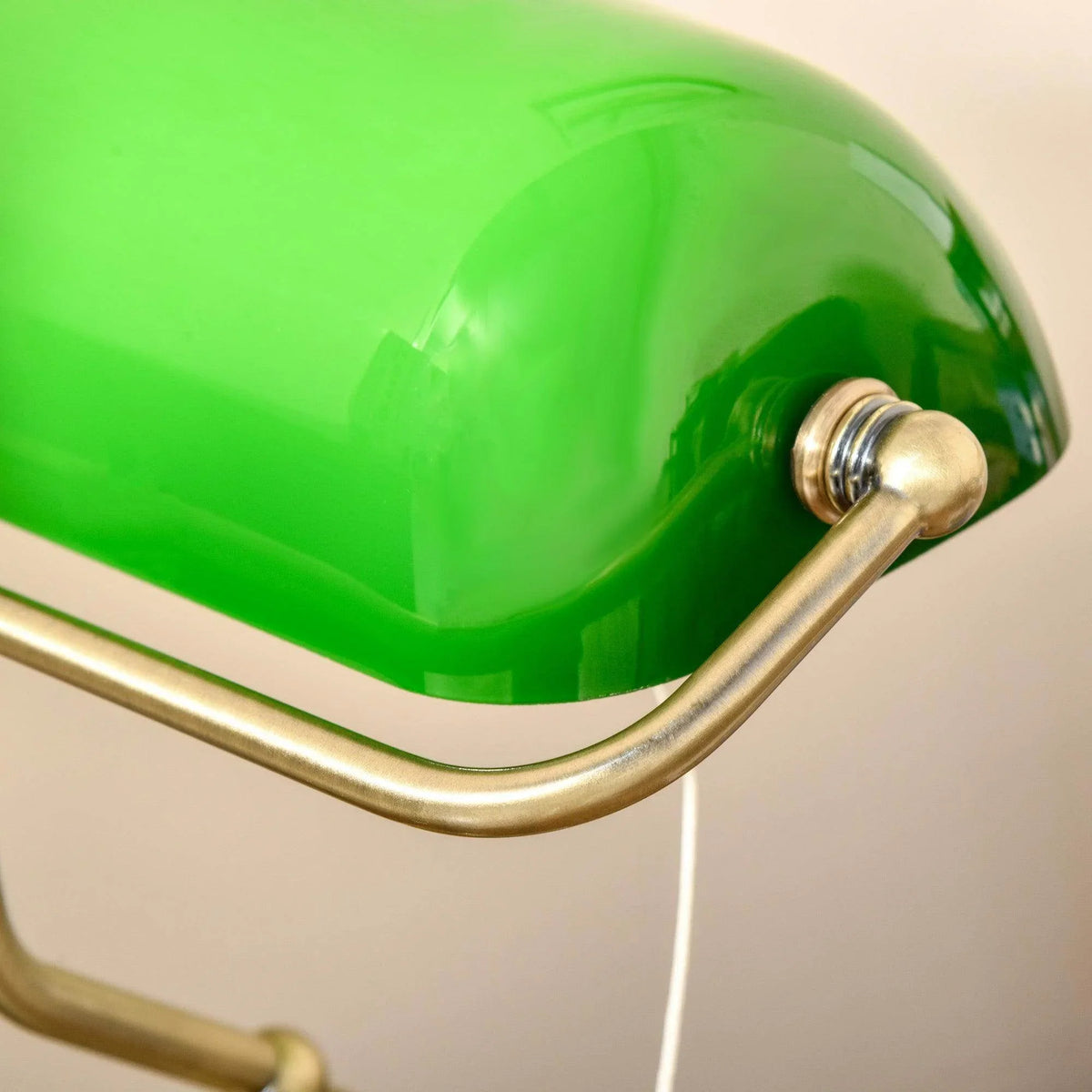 Close-up of green glass dome shade with bronze side bracket and socket