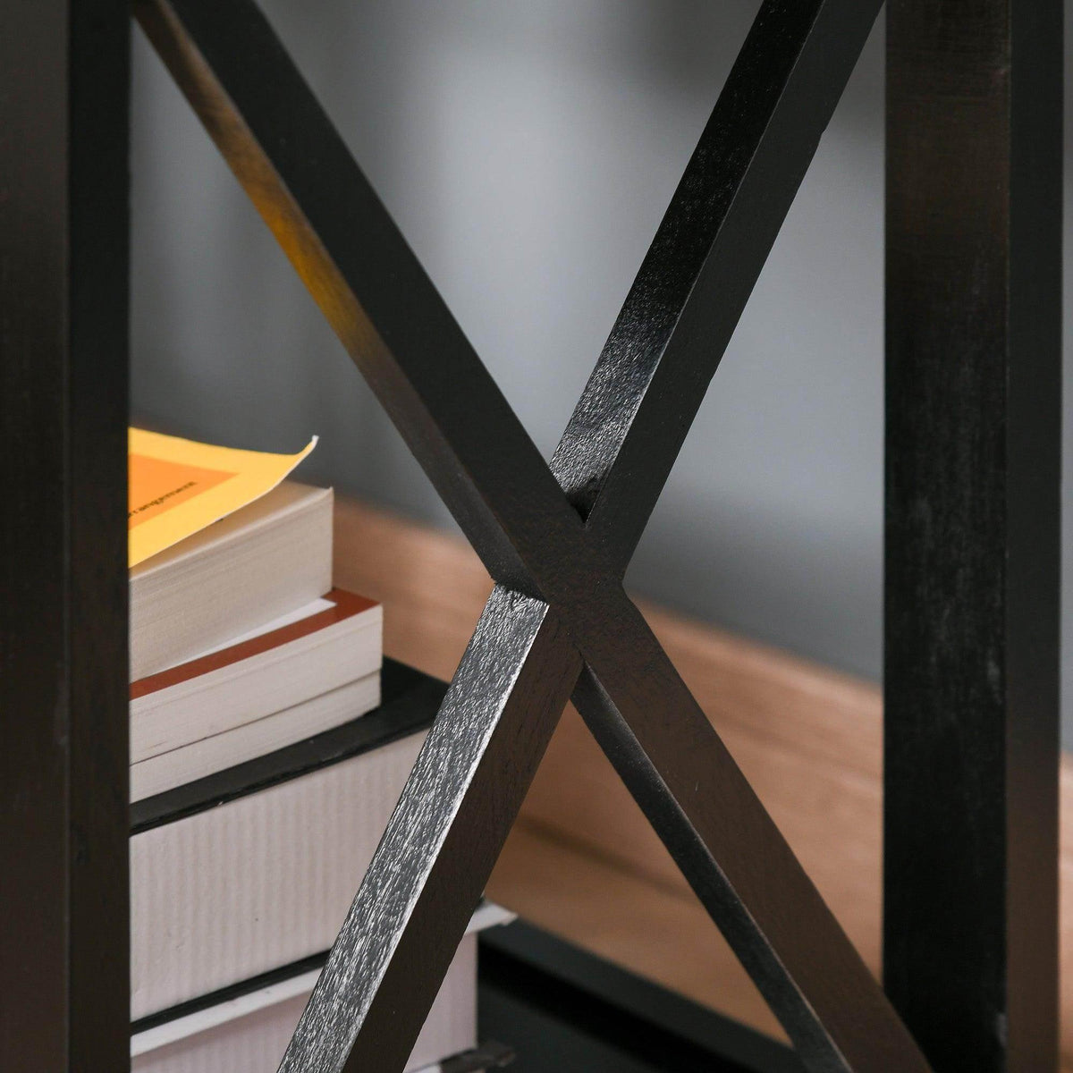 Close-up of black X-frame support on the end table base