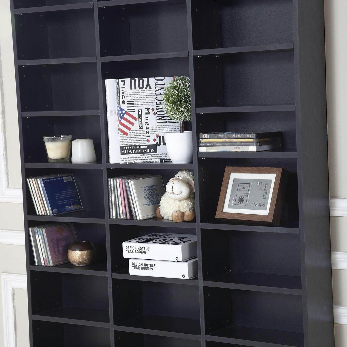 Black book and media organizer cabinet with square compartments holding books and decor