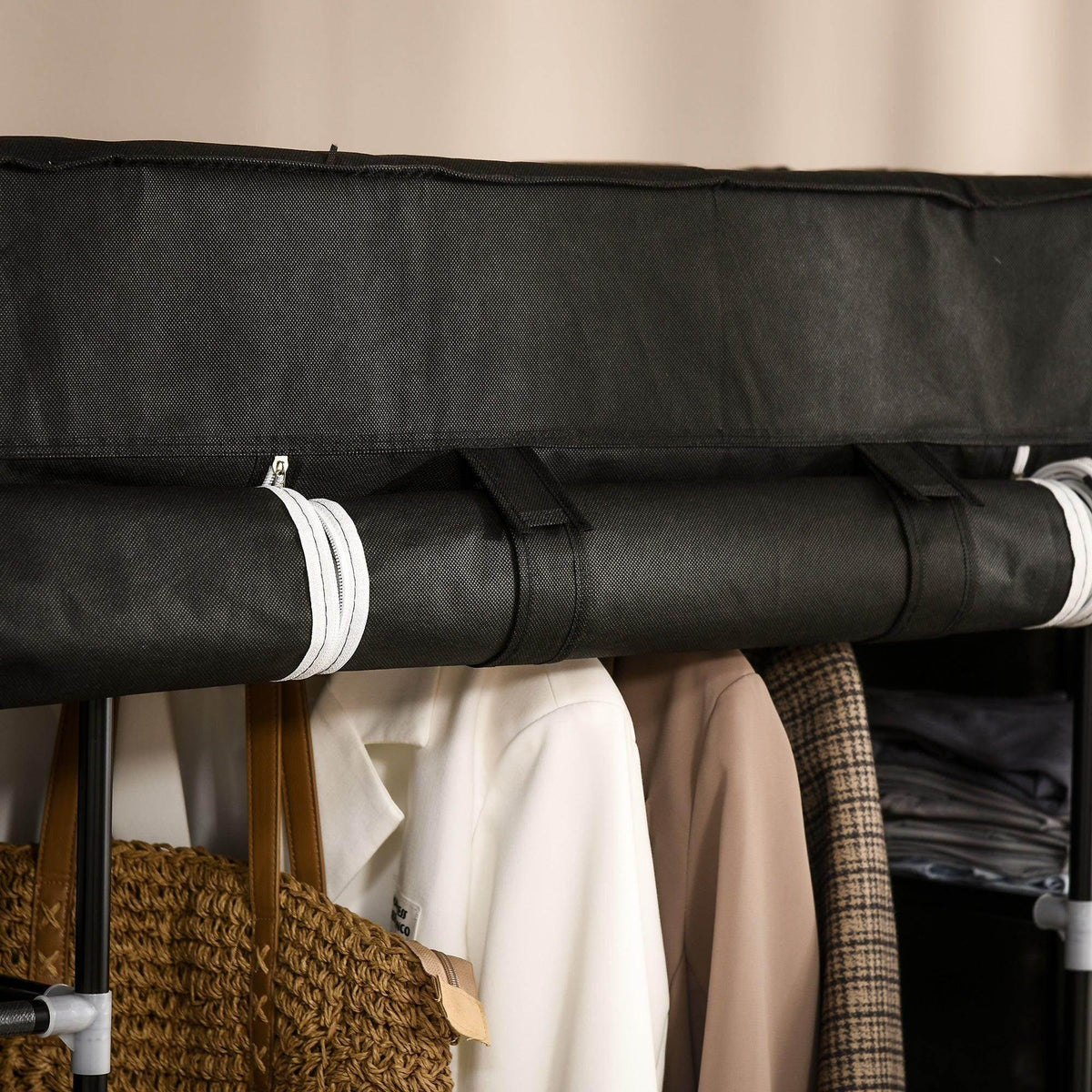 Black fabric wardrobe cover with rolled hanging-rail tube and trim edge