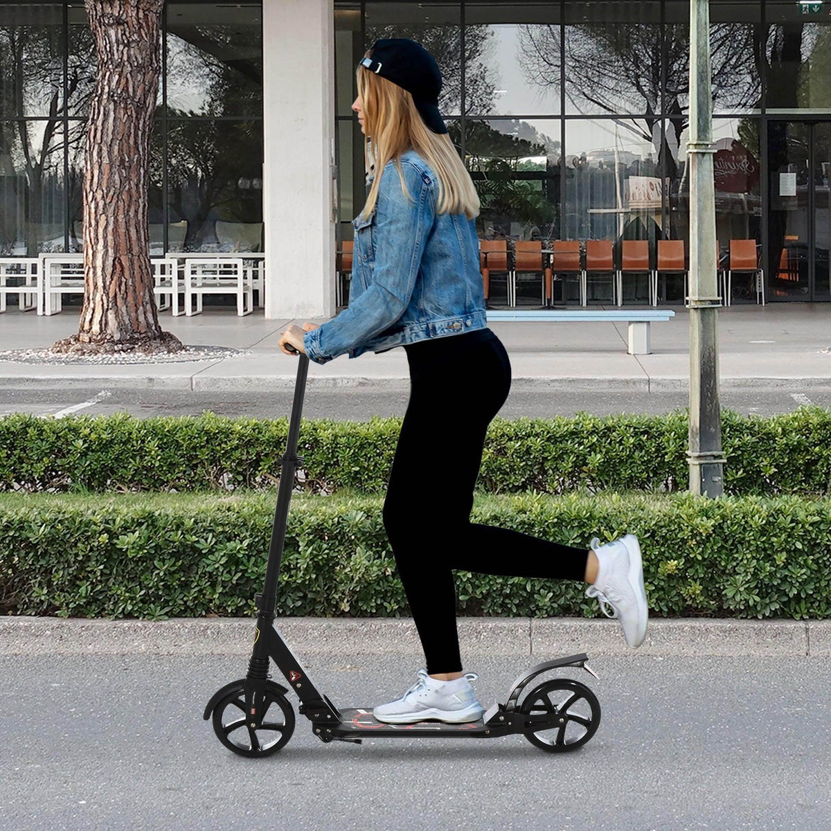 Folding kick scooter with three wheels, black frame and large front and rear wheels