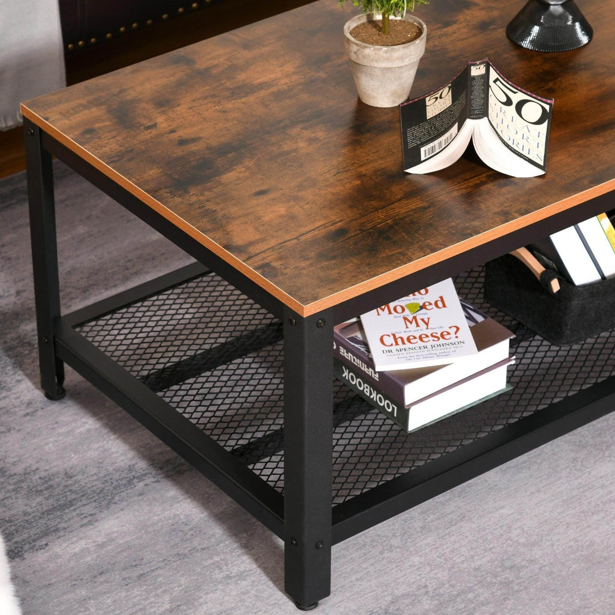 Industrial coffee table with rustic brown top and black metal mesh lower shelf