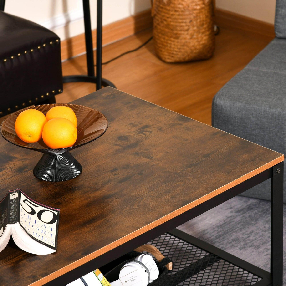 Industrial coffee table with rustic brown surface, black legs, and mesh storage shelf