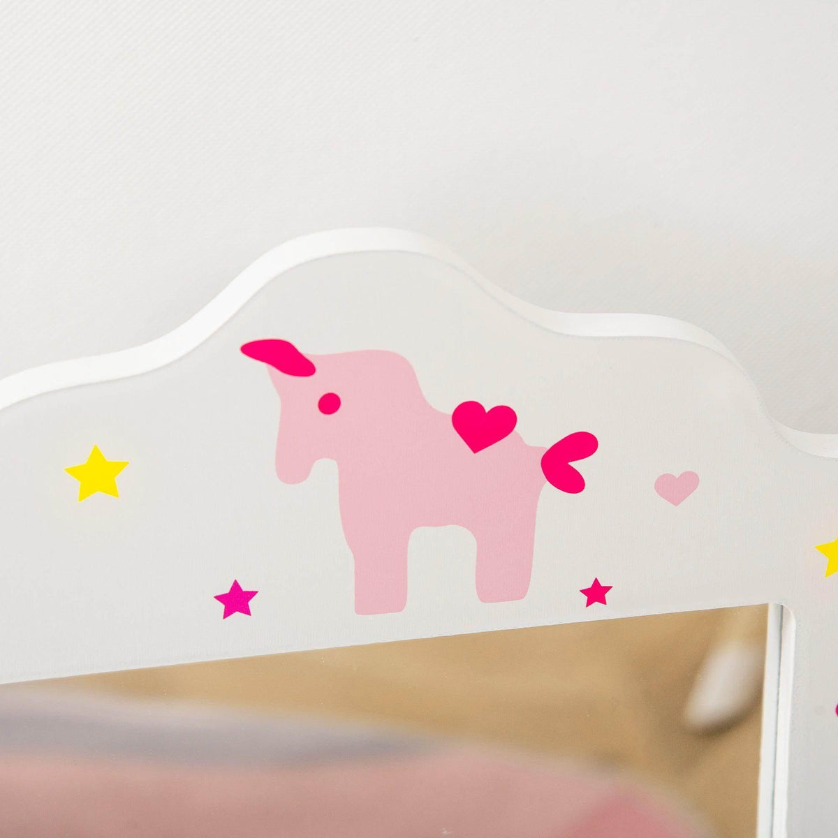 White vanity mirror back panel with colorful unicorn and star decals