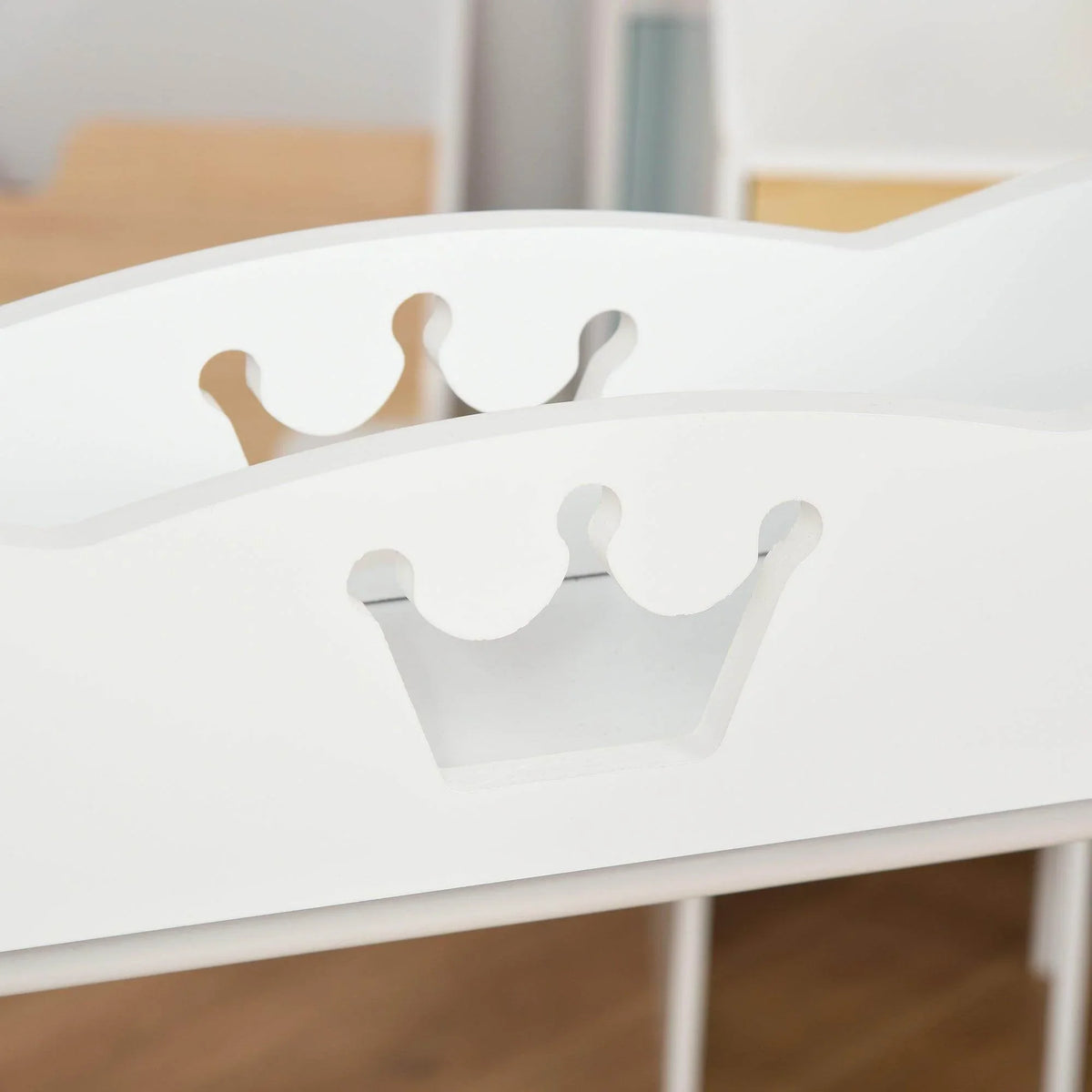 Close-up of white top shelf cutout crown handles on a kids clothes rack