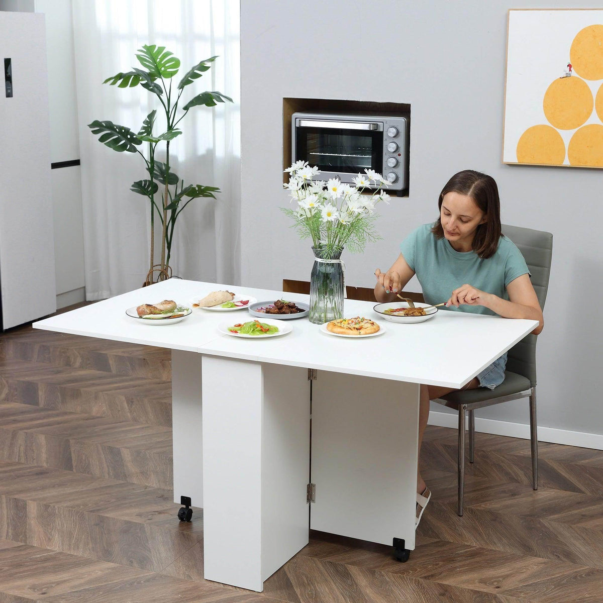 White mobile folding kitchen table with wheels and open shelves, rectangular tabletop