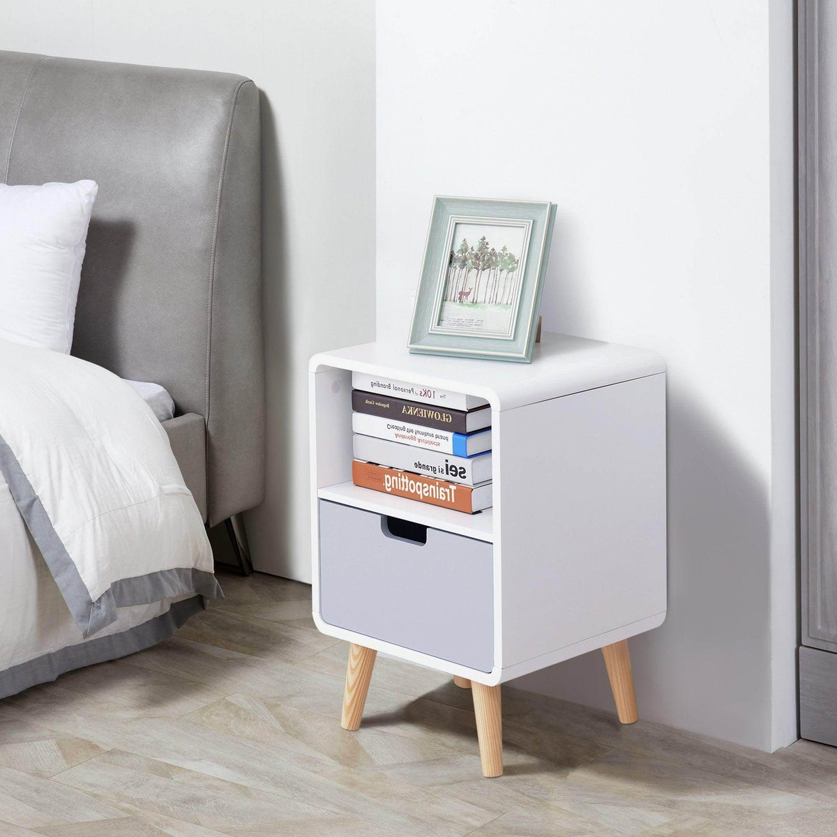 White bedside table with open shelf, drawer, and natural wood legs