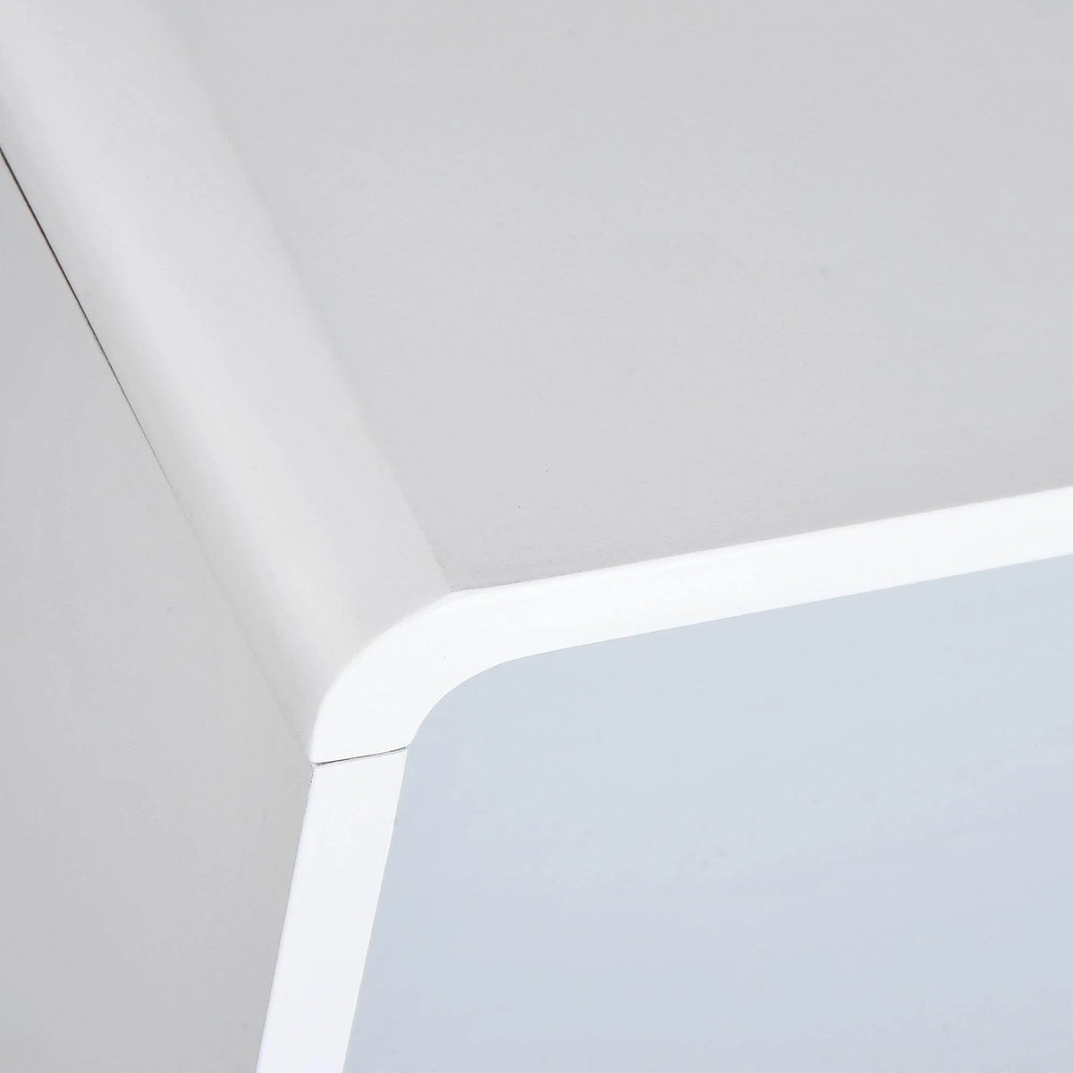 White bedside table with rounded corner edge detail