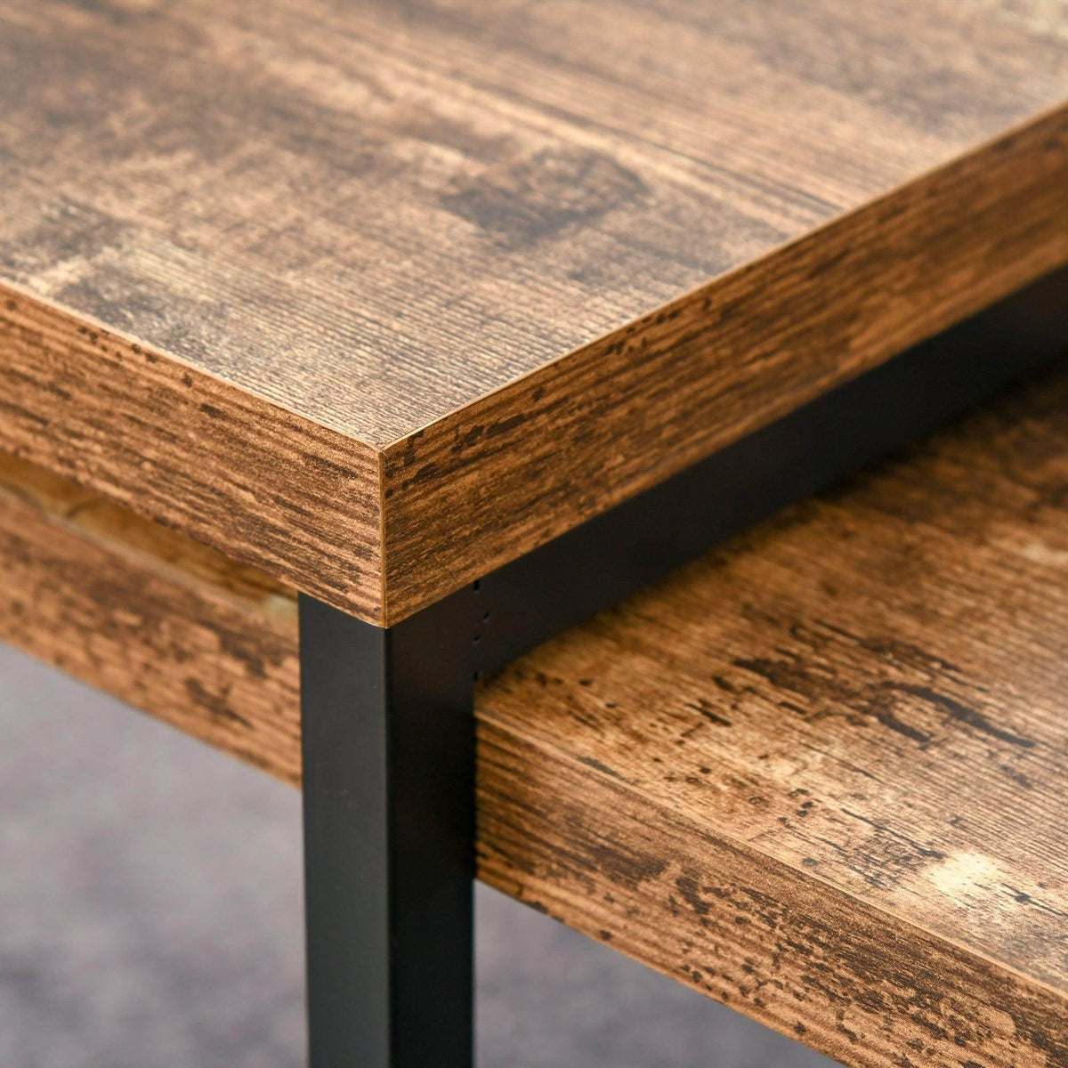 Rustic brown wood tabletop corner with black metal support frame, industrial coffee table