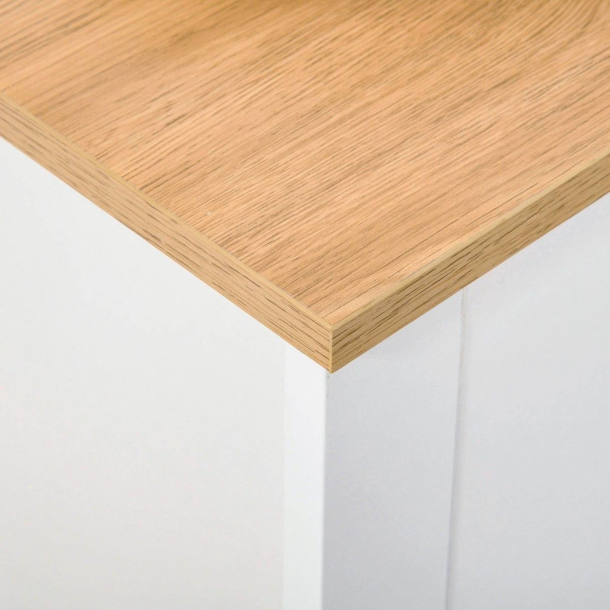 Light wood tabletop corner on a white shoe cabinet.