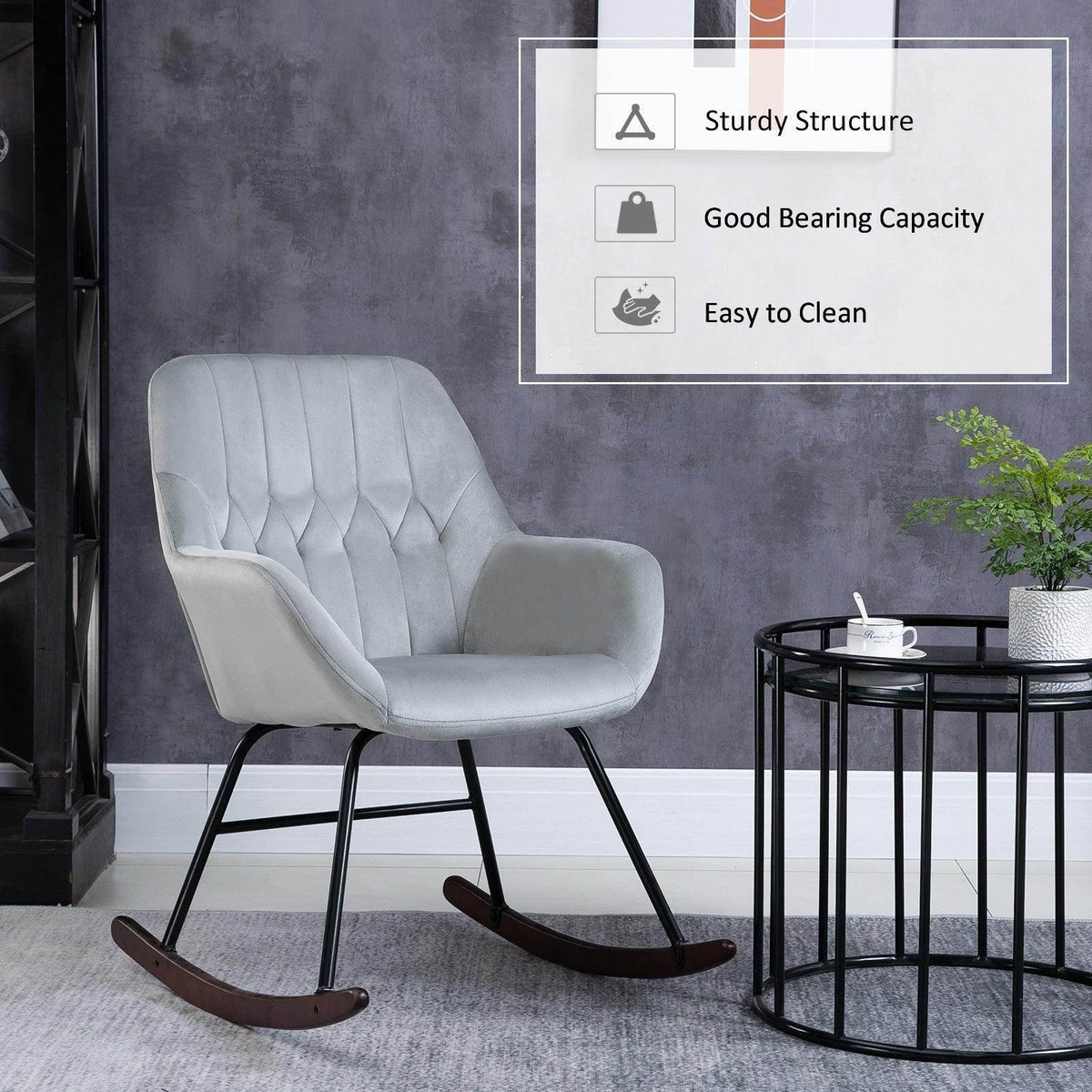 Grey upholstered rocking chair with black metal frame and curved rockers.