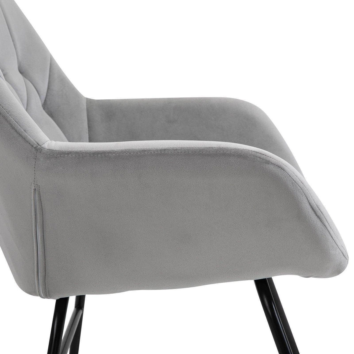 Light grey upholstered armrest and padded side of rocking chair, black legs, brown rocker