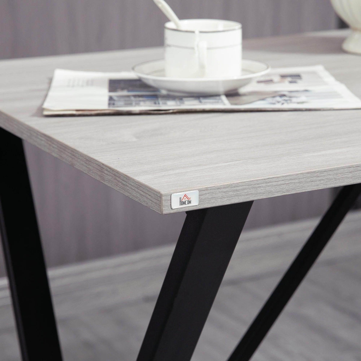 Corner of bar table top with protective edge and black steel leg
