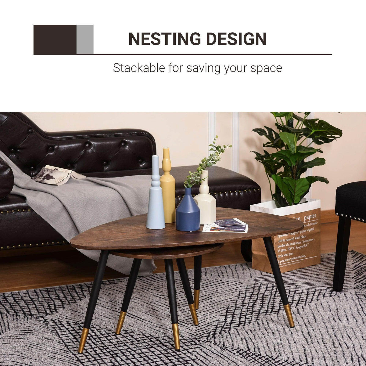 Round coffee table with dark wood top and black tripod legs with gold accents