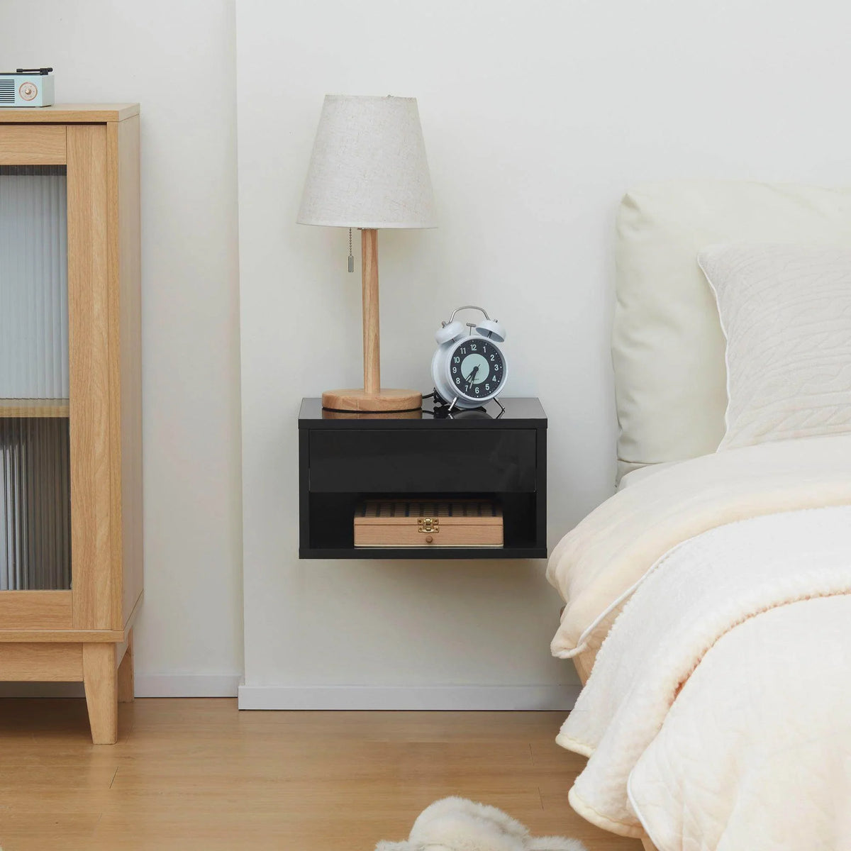 Glossy black wall-mounted bedside table with drawer and open shelf