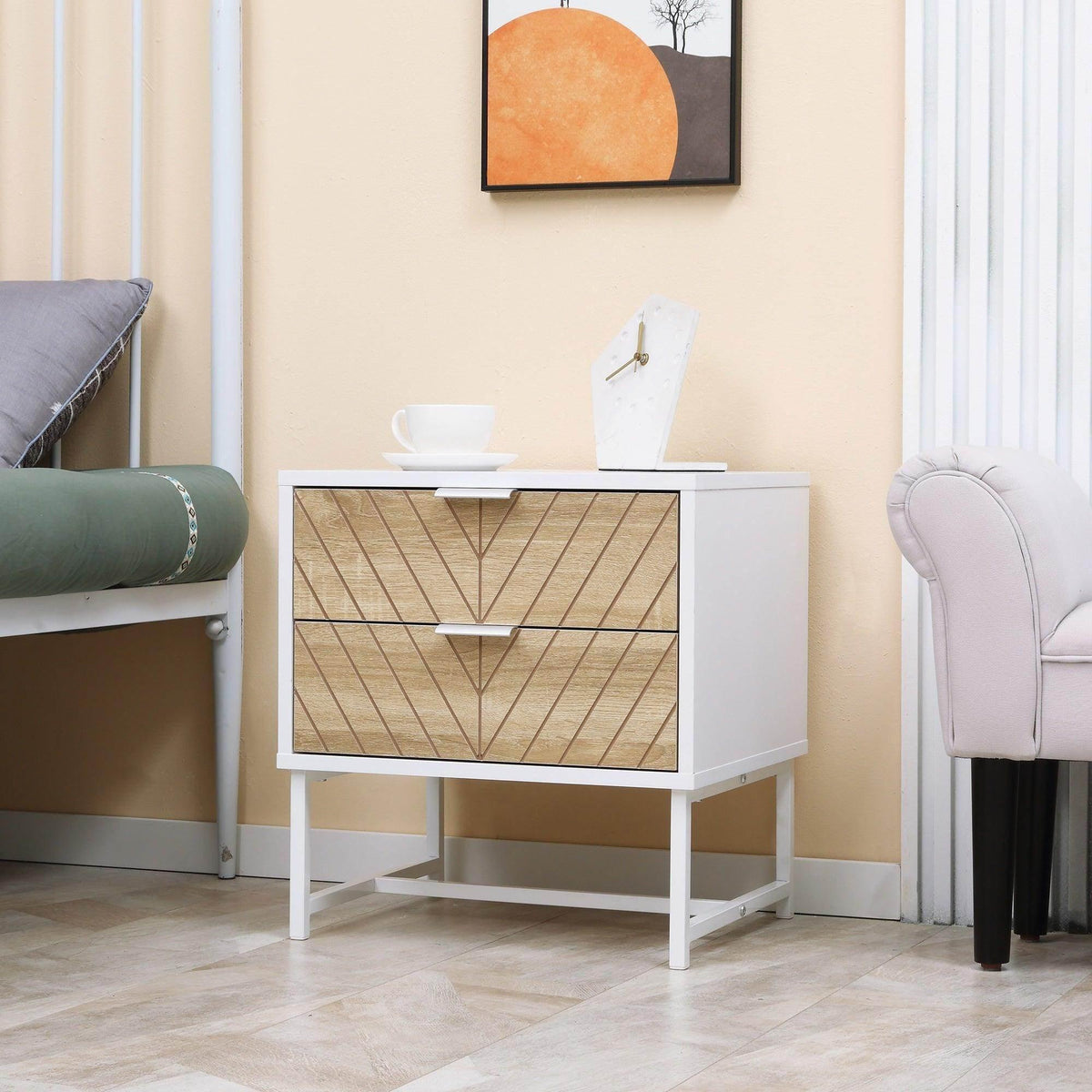 White bedside table with two drawers and gold-toned chevron-pattern fronts, metal legs