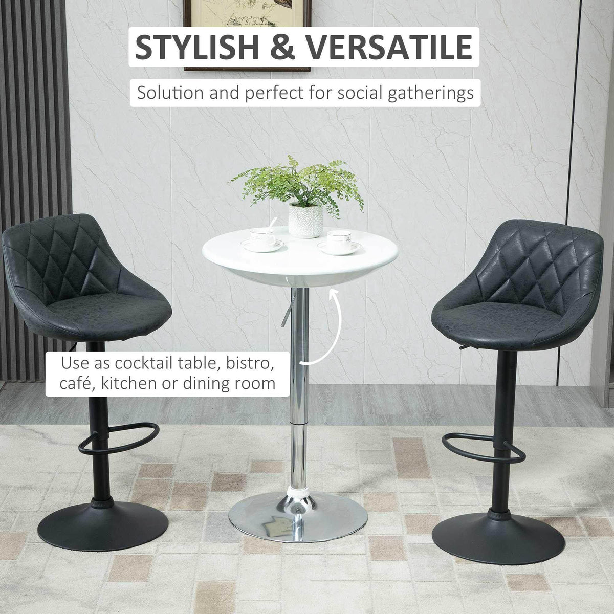 White round bar table with chrome pedestal base, styled with two black stools.