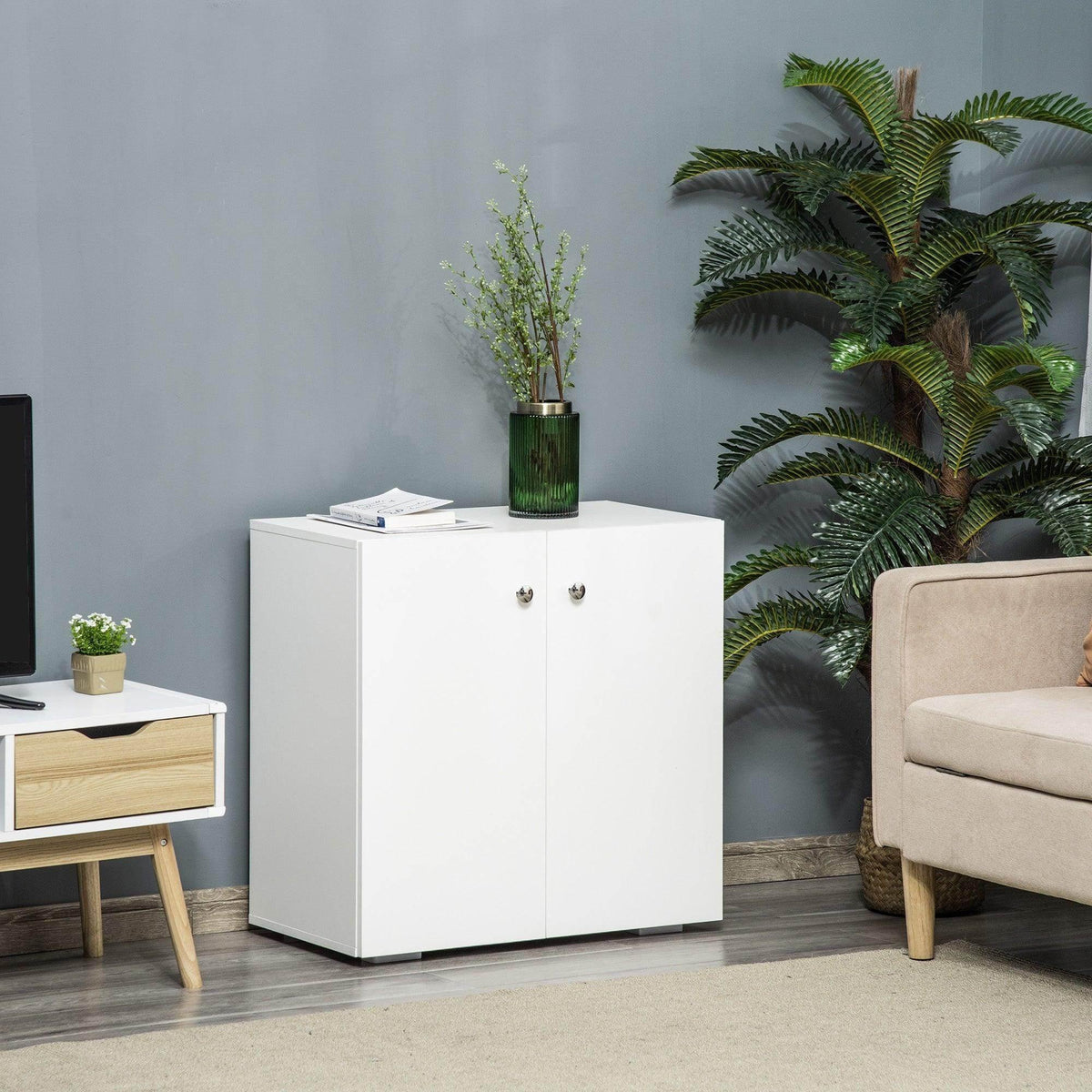 White freestanding storage cabinet with two doors and two interior shelves, round knobs