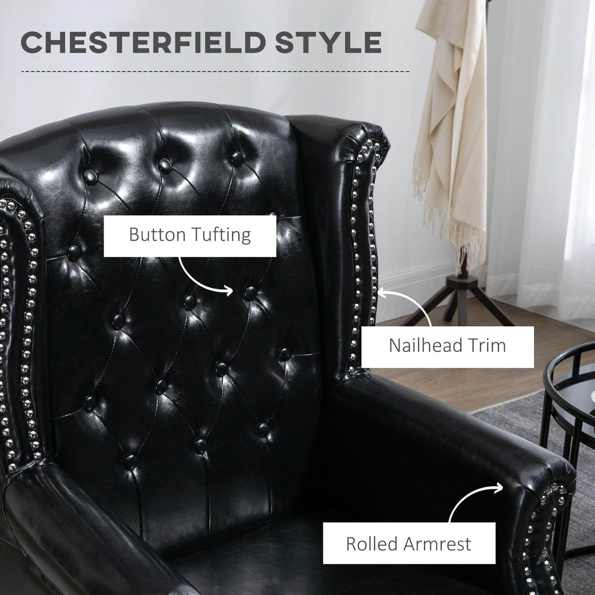 Black wingback armchair with button tufting, rolled armrest, and nailhead trim