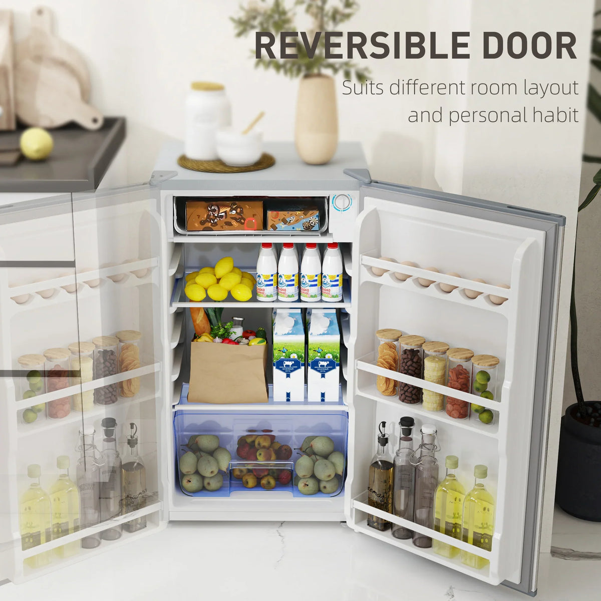 Opened under-counter fridge with reversible door showing freezer and fridge storage bins