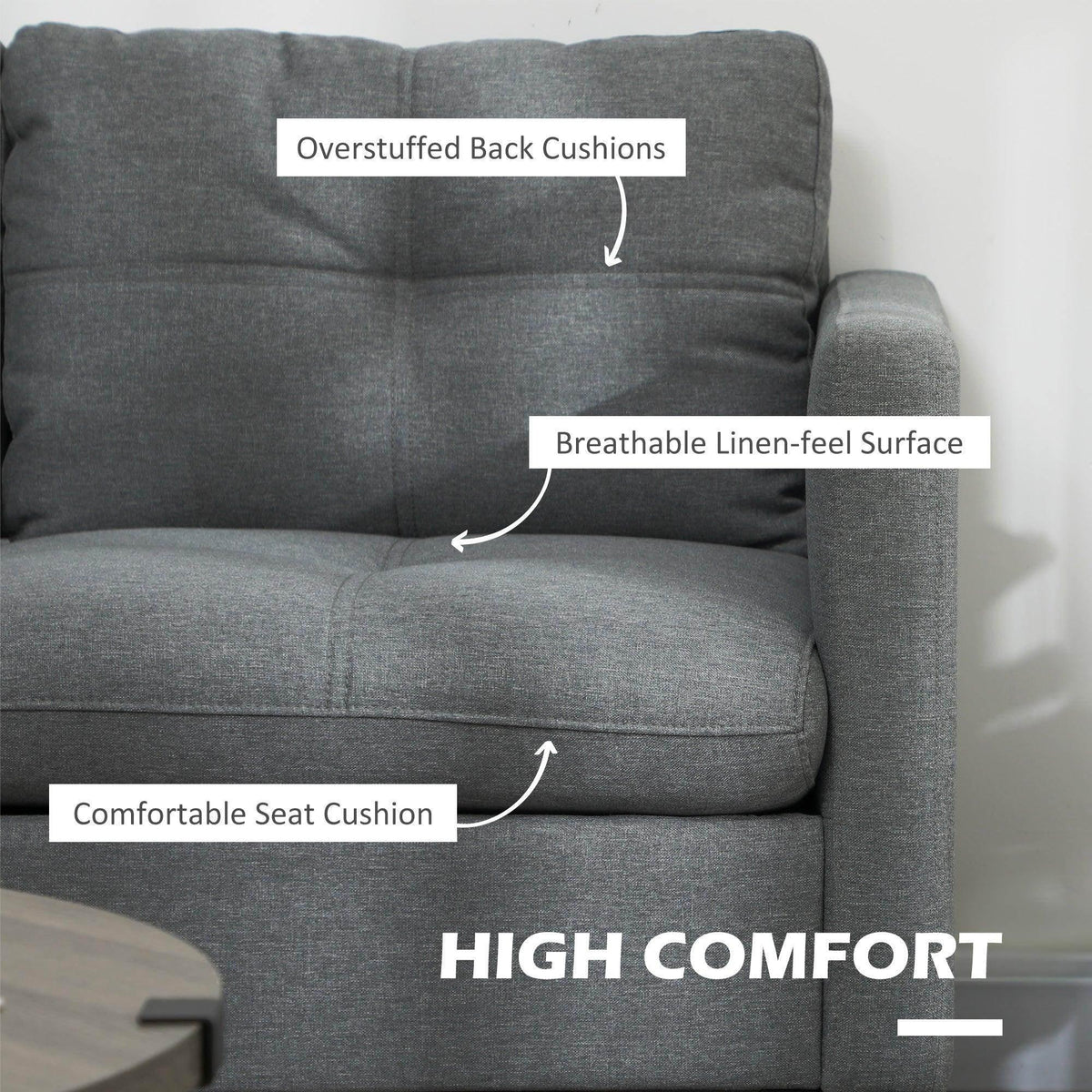 Gray loveseat sofa with overstuffed back cushions and linen-look upholstered surface.