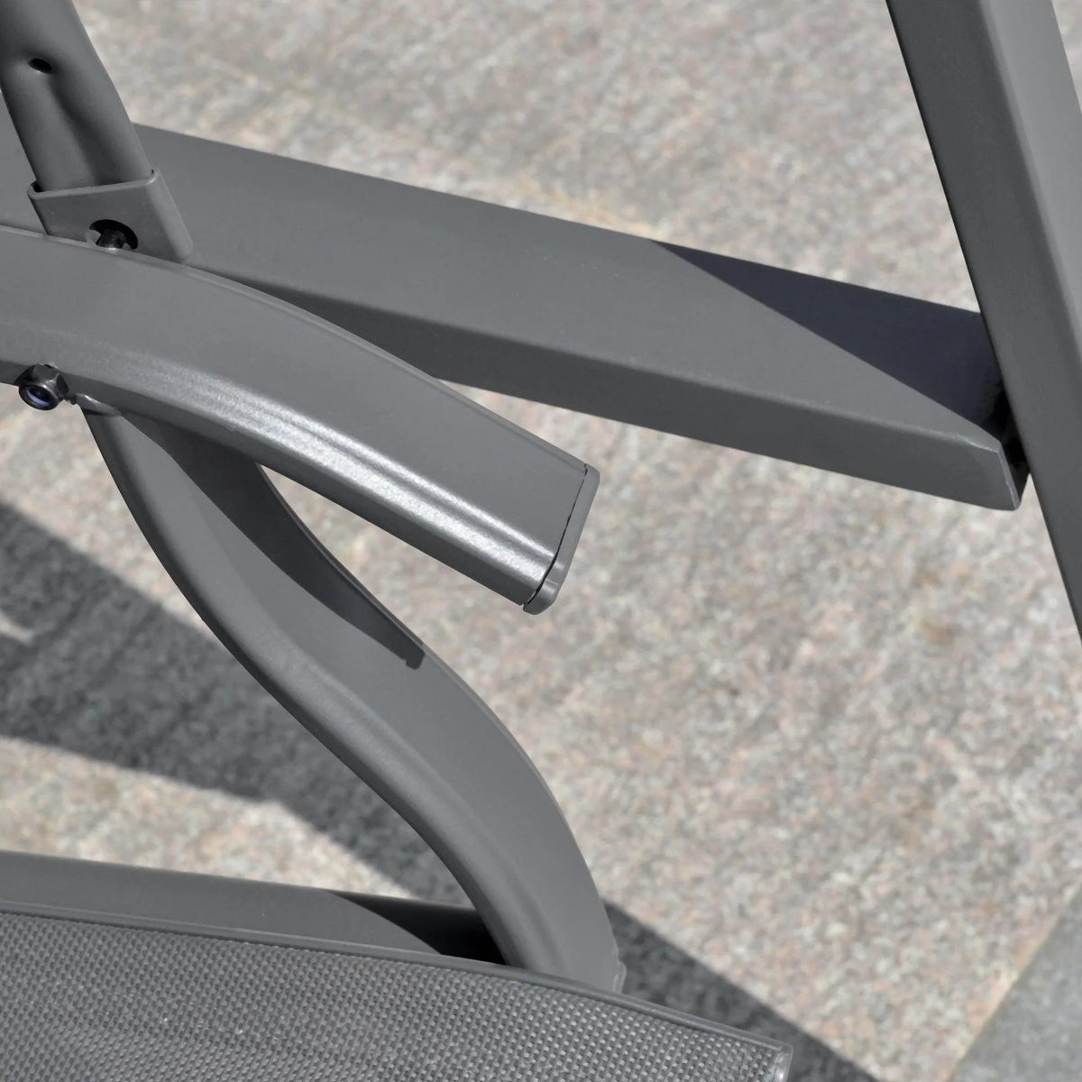 Grey metal canopy support arm and bracket hardware on swing bench frame