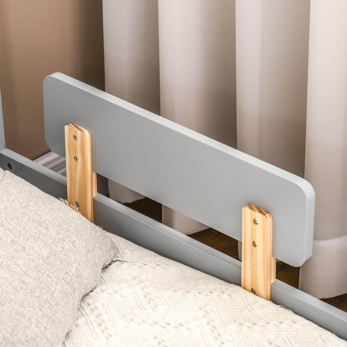 Grey toddler bed end panel with star-moon design and wooden side rails