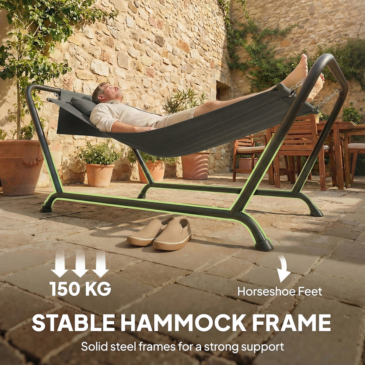 Freestanding hammock stand with horseshoe-style feet and dark grey fabric sling