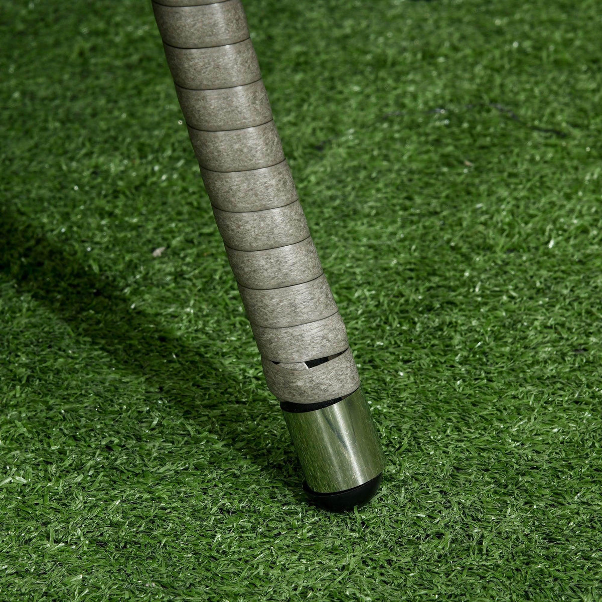 Gray rattan sofa leg with protective floor glides
