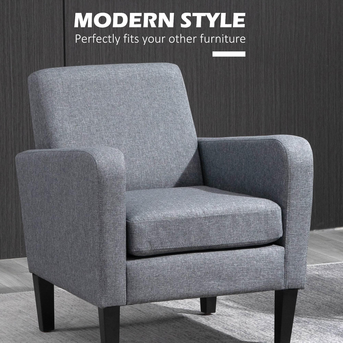 Grey upholstered armchair with rounded back, padded seat, and dark wooden legs