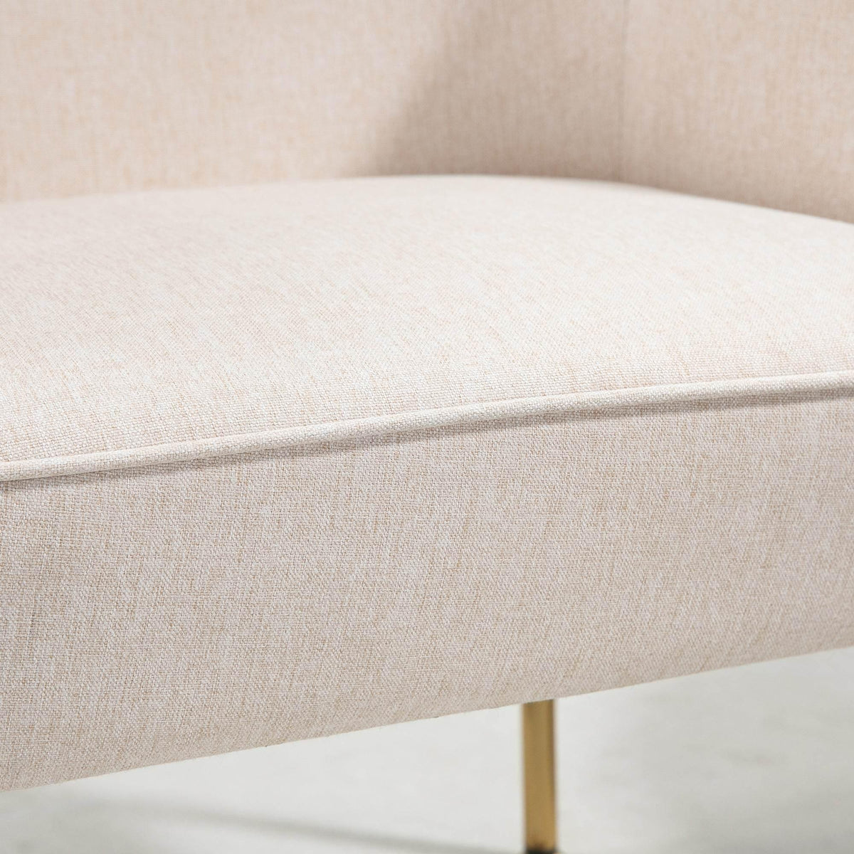 Cream armchair seat cushion close-up with soft textured upholstery