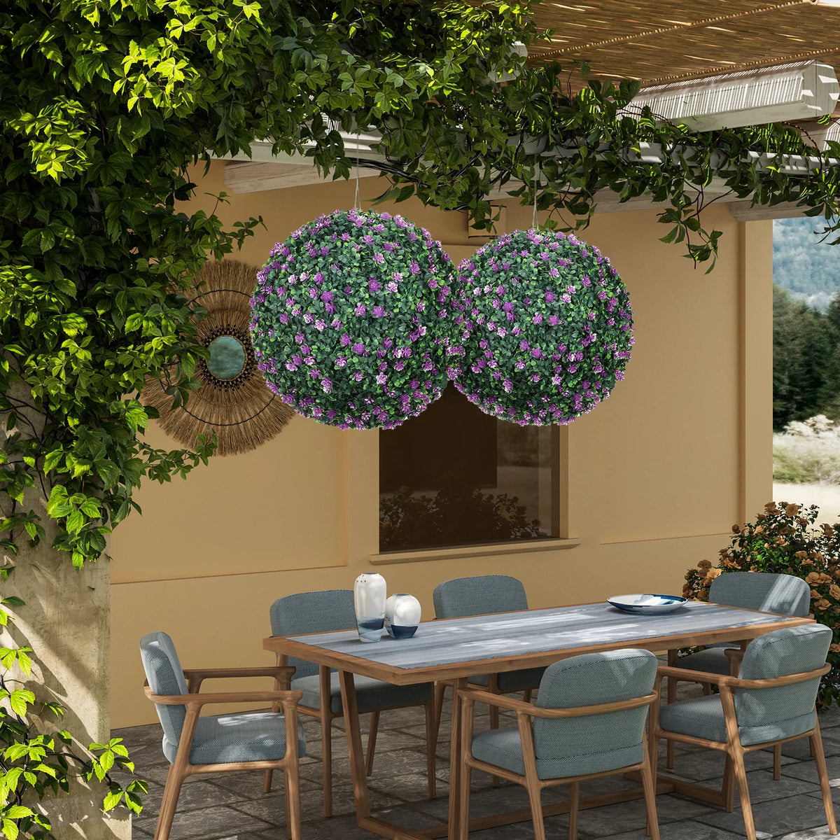 Two artificial purple boxwood ball plants in black pots for patio decoration