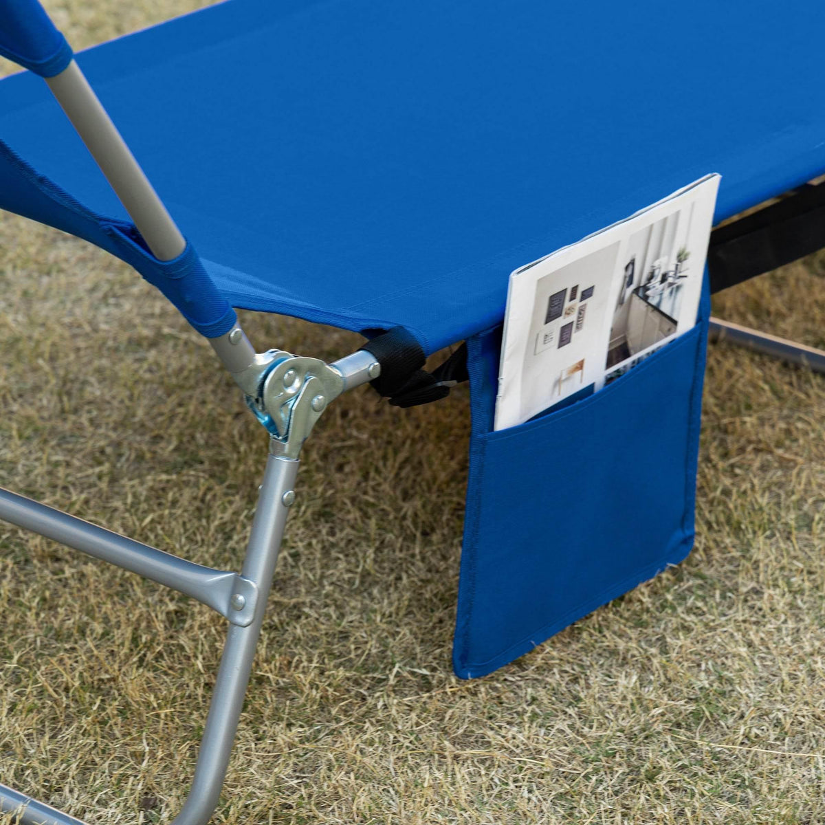 Blue sun lounger side pocket attached to silver steel frame