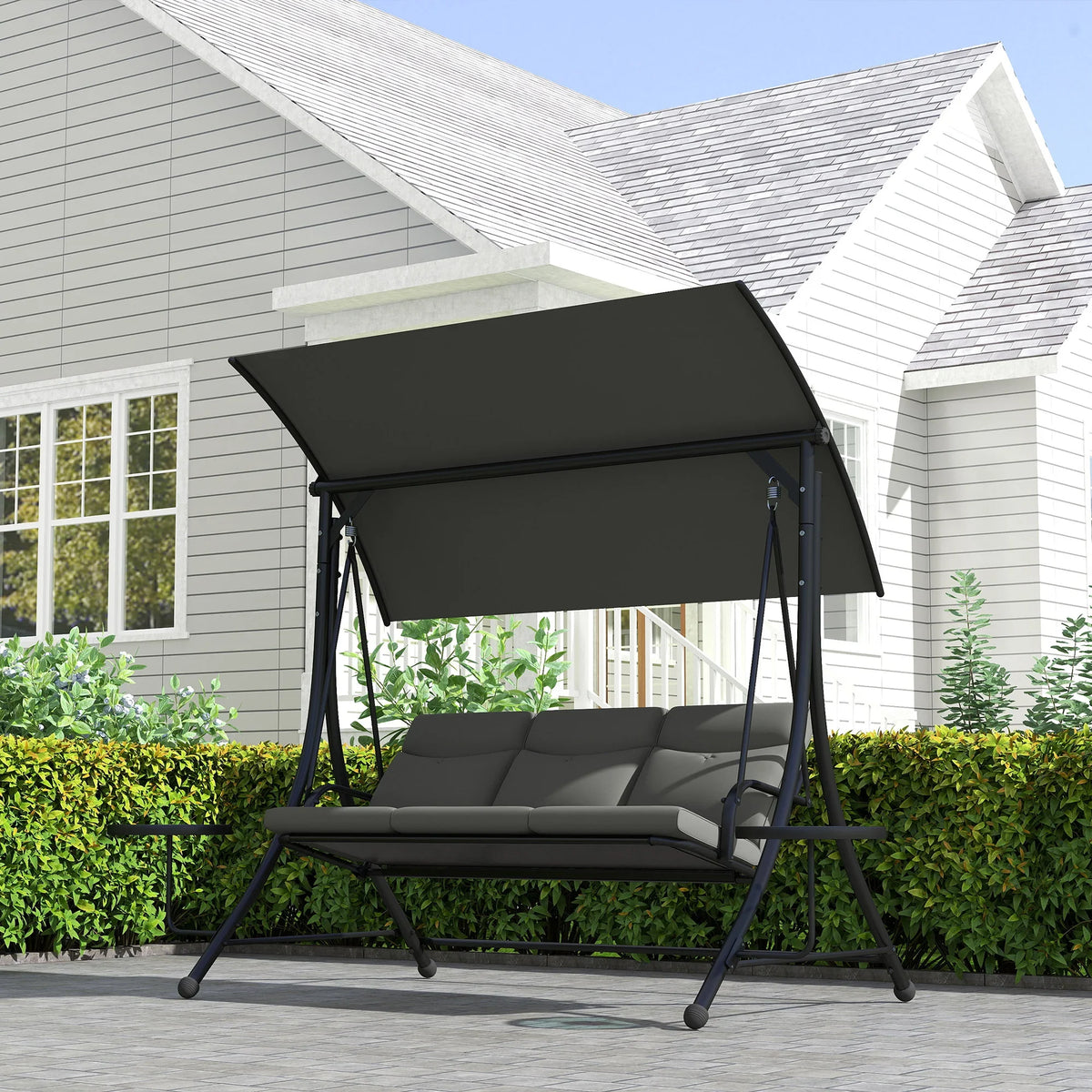 Outdoor three-seater swing with black canopy and grey seat cushions on steel legs