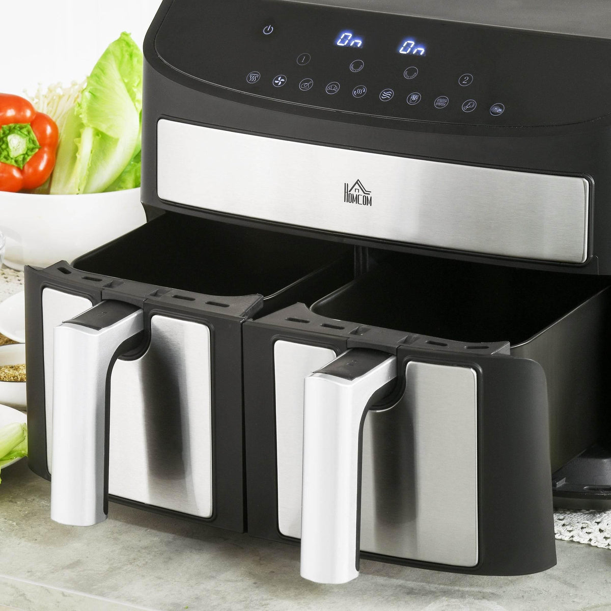 Dual-zone air fryer with open dual baskets and visible stainless drawers in a black housing