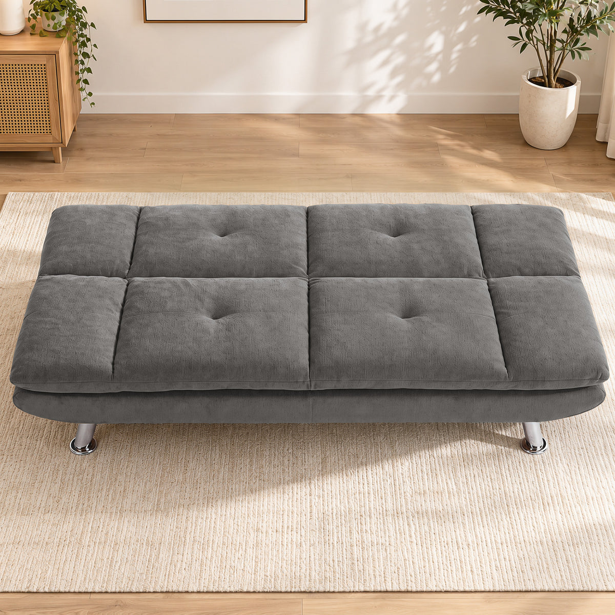 Gray 3-seater convertible sofa bed with tufted seat and four metal legs