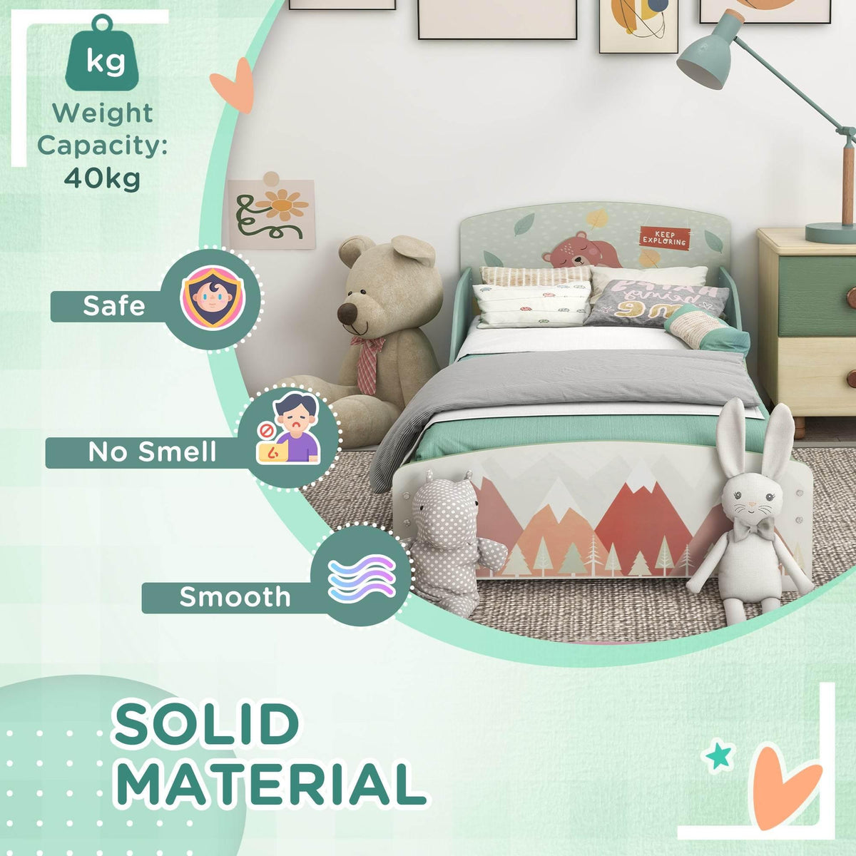 Green toddler bed with patterned headboard and side rail, styled with pillows