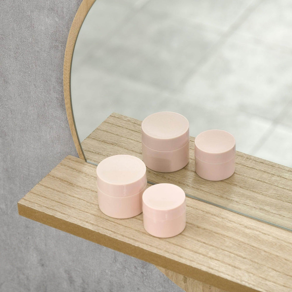 Natural wood shelf beneath a round wall mirror, smooth rounded front edge