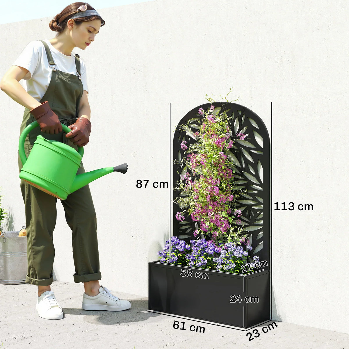 Black metal garden planter with tall curved trellis and leaf-pattern privacy screen