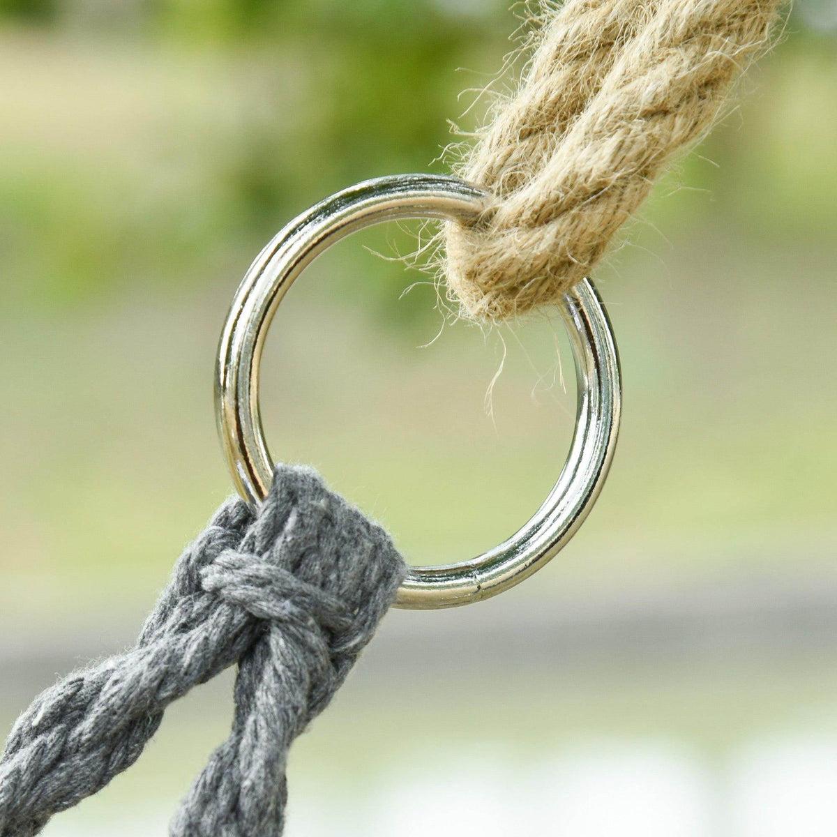 Dark grey hammock chair rope tied to circular metal ring hanger