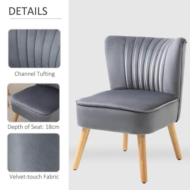 Grey velvet accent chair with channel tufting, cushioned seat, and wooden legs