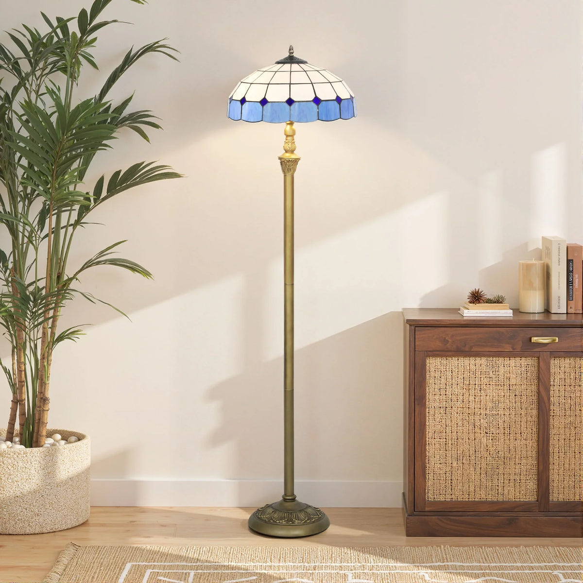 Bronze floor lamp with blue stained-glass dome shade standing on floor