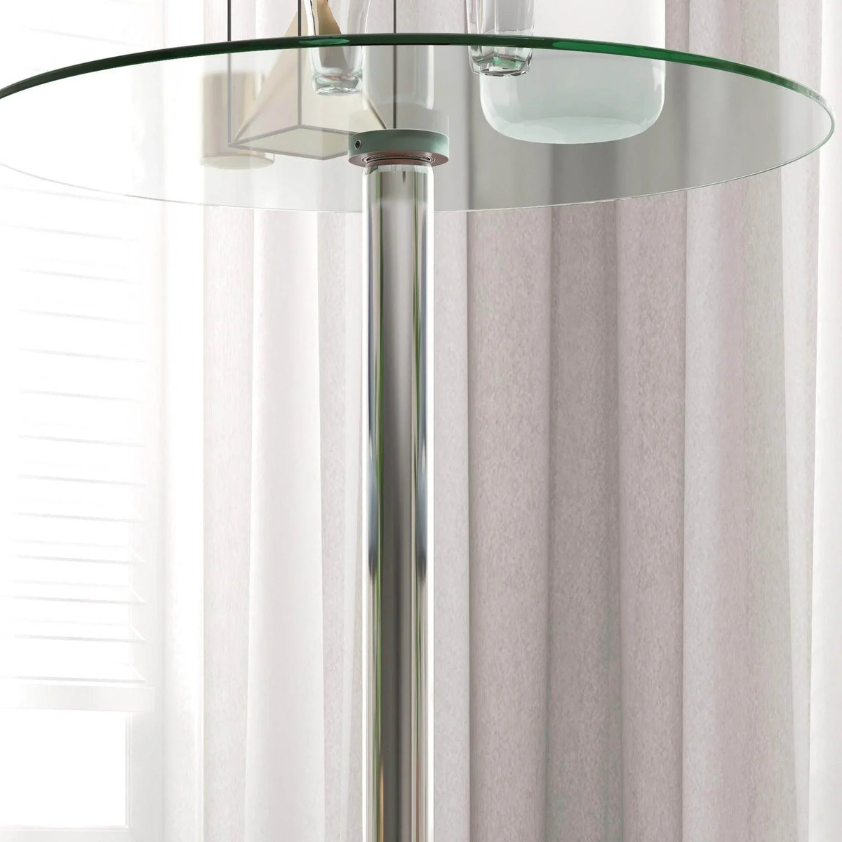 Close-up of clear glass bar table top edge on chrome steel pedestal